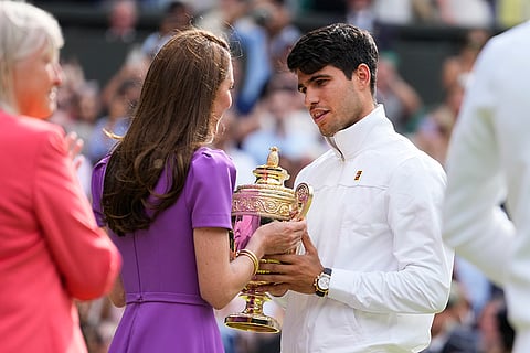 Carlos Alcaraz receives his trophy from Kate, Princess of Wales